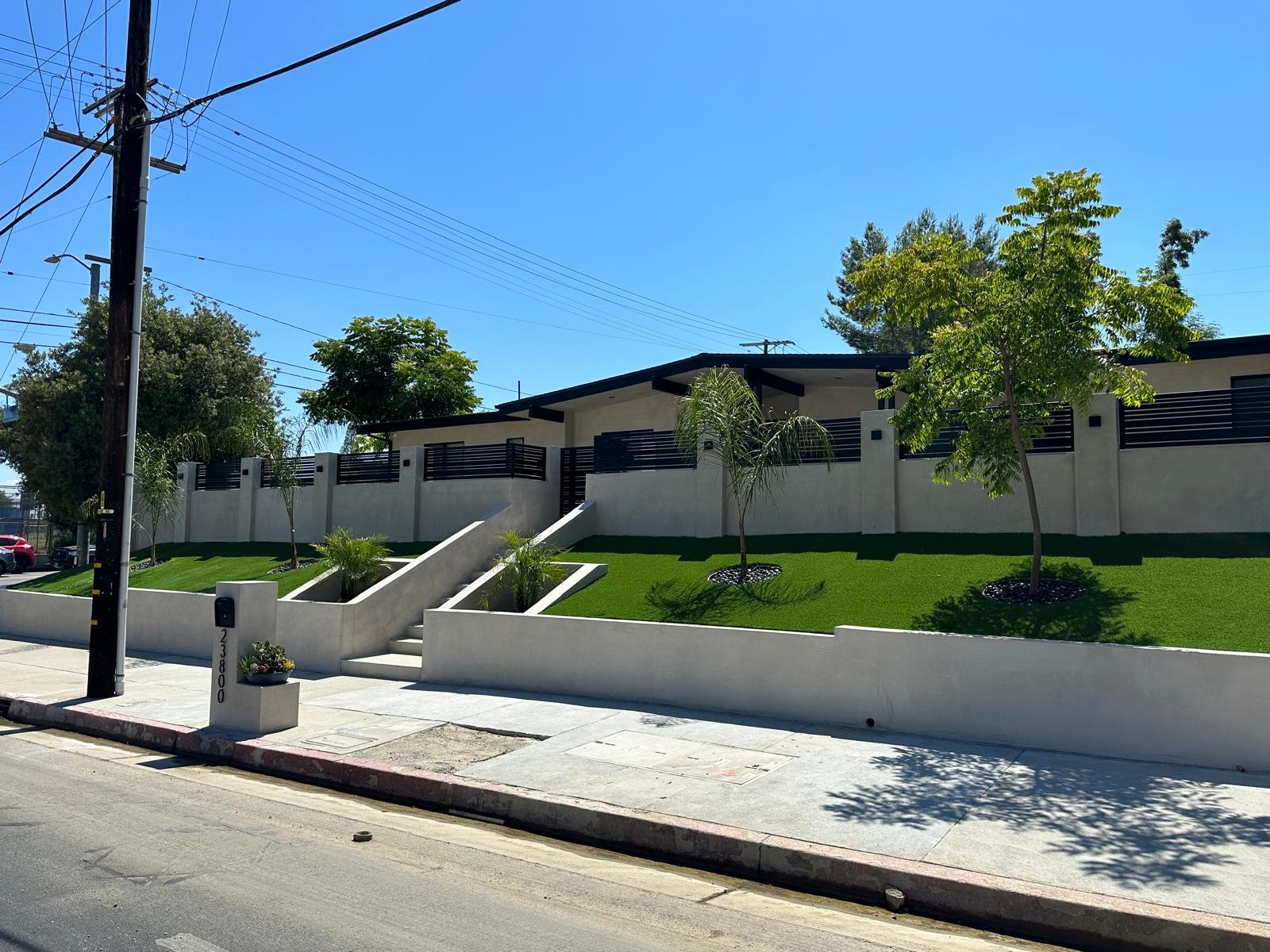 Front yard and exterior remodel in Van Nuys featuring new landscaping, modern facade, and upgraded entryway.